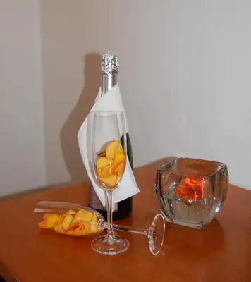 a wine glass and a bottle on a table at Penzion Pri Slovenc in Dol pri Ljubljani