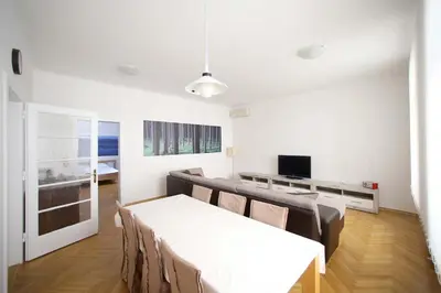 a living room with a white table and chairs at Skyscraper Apartment Tour As Ljubljana in Ljubljana