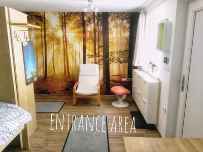 a bedroom with a painting of a forest at River Cave Apartment Slovenia in Visoko