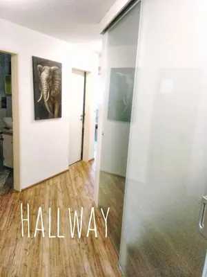 a hallway with an elephant painting on a wall at River Cave Apartment Slovenia in Visoko