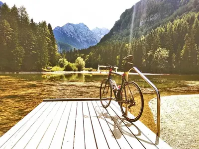 a bike parked on a dock next to a lake at River Cave Apartment Slovenia in Visoko