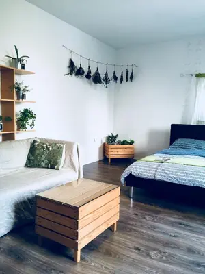 a bedroom with a bed and a coffee table at Urban herbs apartment in Ljubljana