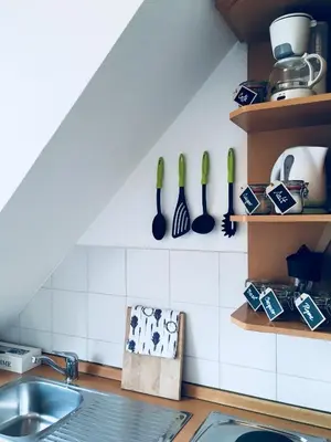 a kitchen with a sink and utensils on the wall at Urban herbs apartment in Ljubljana