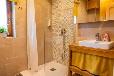 a bathroom with a sink and a shower at Kmečka Hiška - Hiša vina Cuk in Lendava