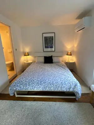 a bedroom with a large bed with two lamps at Ciginj old stone house in Čiginj