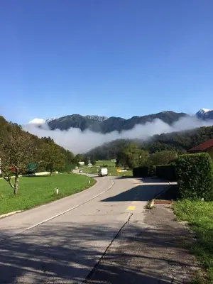 an empty road with a view of a mountain at Ciginj old stone house in Čiginj