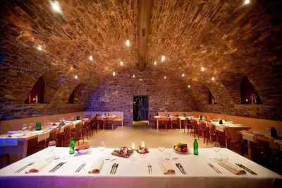 a large room with tables and chairs in a building at Hiša posebne Sorte in Kodreti