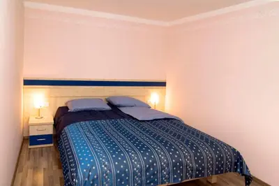 a bedroom with a bed with two pillows on it at Hiša posebne Sorte in Kodreti