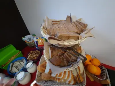 a stack of baskets filled with different types of bread at Hotel Prunk in Sežana