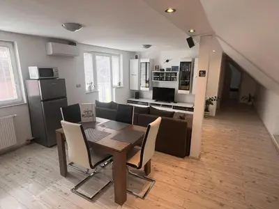a kitchen and dining room with a table and chairs at Ana`s place in Celje