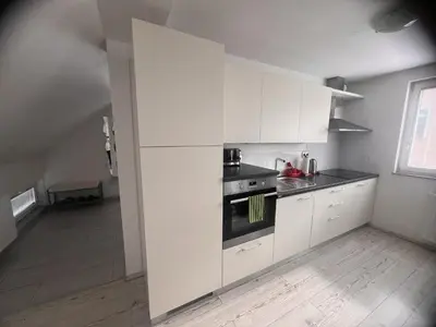 a kitchen with white cabinets and a stove at Ana`s place in Celje