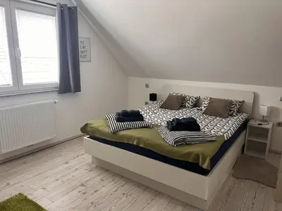 a bedroom with a bed in a white room at Ana`s place in Celje