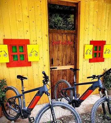 two bikes parked outside of a building with a door at Shepherds House 