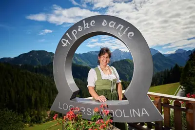 a woman standing in a sign in the mountains at Shepherds House 