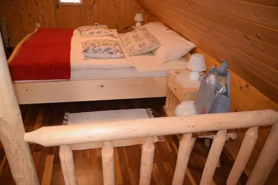 a bedroom with a bed in a log cabin at Shepherds House 