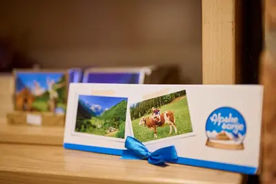 a card with two pictures and a blue bow at Shepherds House 