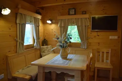 a dining room with a wooden table and a tv at Shepherds House 