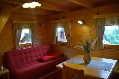 a living room with a red couch and a table at Shepherds House 