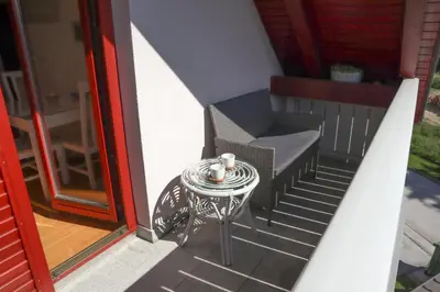 a small table and chair on a balcony at B8 apartment in Bohinj