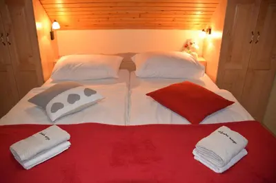 a bed with two pillows and two towels on it at Farm Stay 