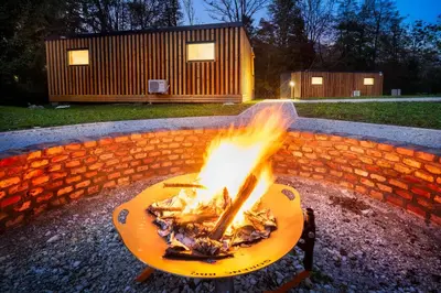 a fire pit in a yard with flames in it at Pearl of Sava Wild Waters in Ljubljana