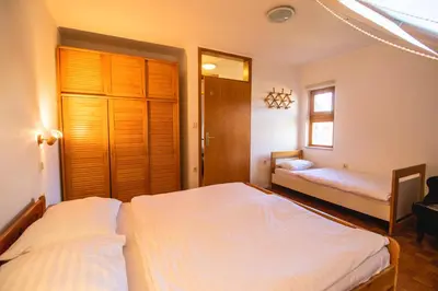 a bedroom with two beds and a window at POČITNIŠKI APARTMAJI - Extraordinary apartment in Banovci in Veržej