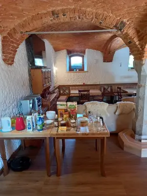 a living room with a wooden table in a house at Apartments Tubej in Bohinj