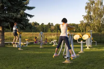a woman is playing on a playground in a park at Grand Hotel Primus - Terme Ptuj - Sava Hotels & Resorts in Ptuj