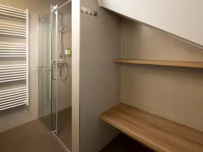 a bathroom with a shower and a walk in closet at Ahotel Ljubljana in Ljubljana