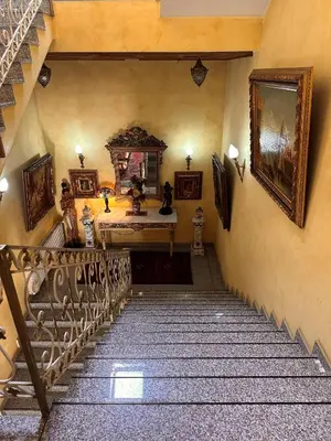 a staircase leading up to a room with a stair case at Hotel Grande in Celje
