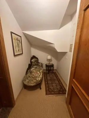 an attic room with a couch and a table at Hotel Grande in Celje