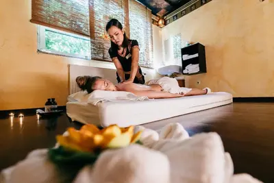 a woman is laying on a bed with a girl at Hotel Vivat in Moravske Toplice