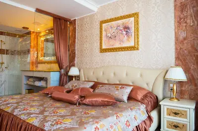 a bedroom with a bed with pillows on it at Grand Hotel Donat Superior & Wellness Center in Rogaška Slatina