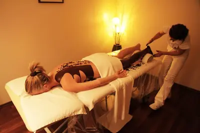 a girl laying on a bed in a room with two women at Grand Hotel Donat Superior & Wellness Center in Rogaška Slatina