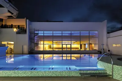a swimming pool in front of a building at night at Grand Hotel Donat Superior & Wellness Center in Rogaška Slatina