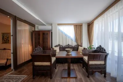 a living room with a dining room table and chairs at Grand Hotel Donat Superior & Wellness Center in Rogaška Slatina