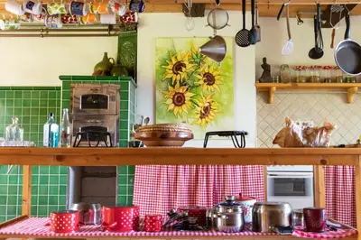 a kitchen with a table with pots and pans at Country House Zunko in Jelovec