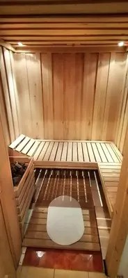 a small sauna with a white bench in the middle at Country House Zunko in Jelovec