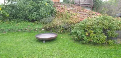 a bath tub sitting in the grass in a yard at Country House Zunko in Jelovec