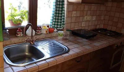 a kitchen counter with a sink and a window at Apartma Lipek in Pristava