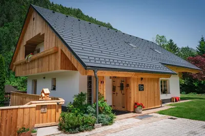 a large house with a gambrel roof at Apartments Trata in Kranjska Gora