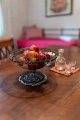 a bowl of fruit on a wooden table at Apartments Trata in Kranjska Gora