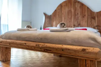 a wooden bed with towels on top of it at Apartments Trata in Kranjska Gora