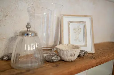 a shelf with glass vases and a picture on it at Apartments Trata in Kranjska Gora