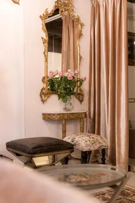 a mirror and a chair in a room at AB Ljubljana - The Residence in Ljubljana
