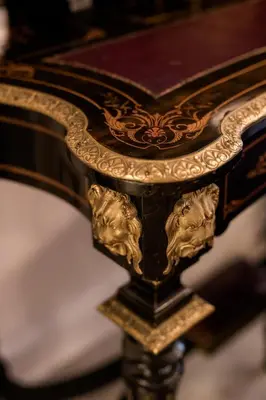 a gold and black table with a book on it at AB Ljubljana - The Residence in Ljubljana
