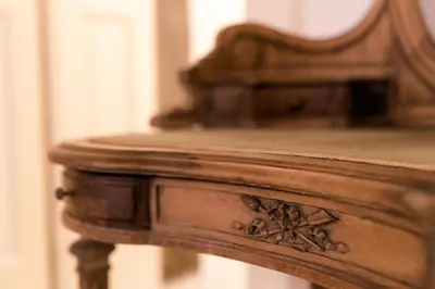 a close up of a wooden table with a mirror at AB Ljubljana - The Residence in Ljubljana