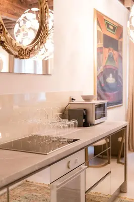 a kitchen with a counter with a microwave and a mirror at AB Ljubljana - The Residence in Ljubljana
