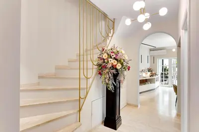 a hallway with a staircase with a floral wreath at Bloom Hotel in Ljubljana