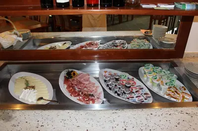 a buffet with many different types of food on plates at Guesthouse Veranda in Mojstrana